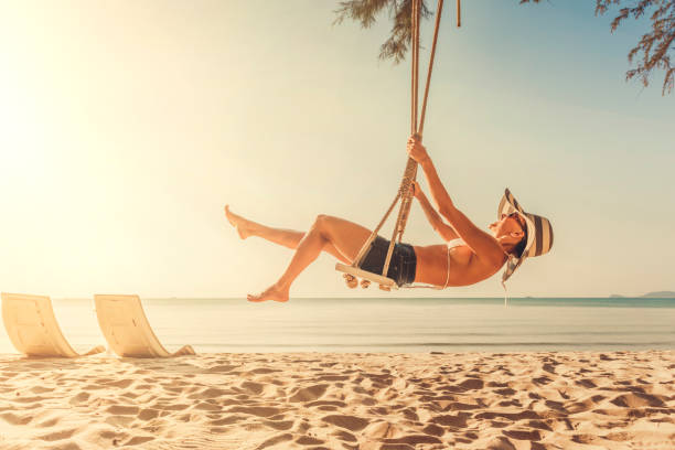 istock Woman at tropical swing 908347614