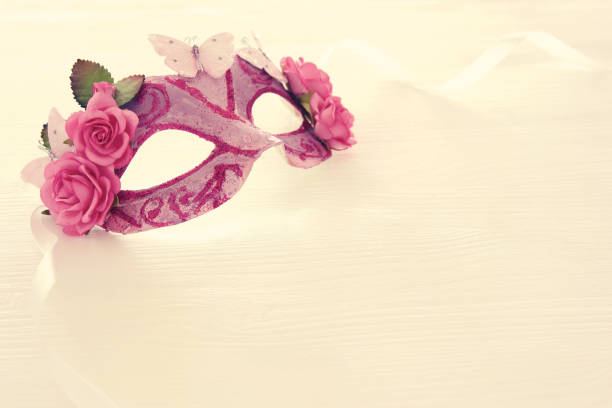 istock Image of delicate elegant venetian mask over wooden white background. Selective focus. 908347650