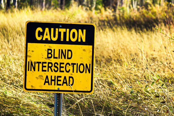 istock Closeup of a Caution Blind Intersection Ahead sign 908353704