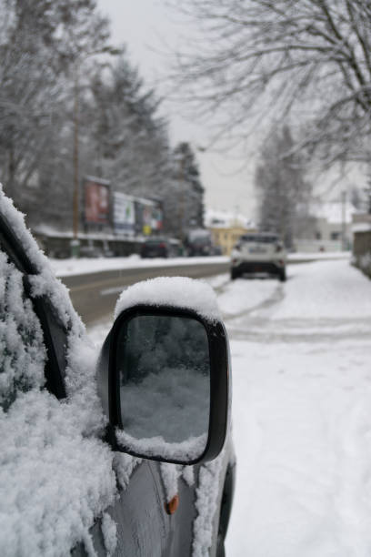 istock Rear car mirror with snow during winter. 908359396