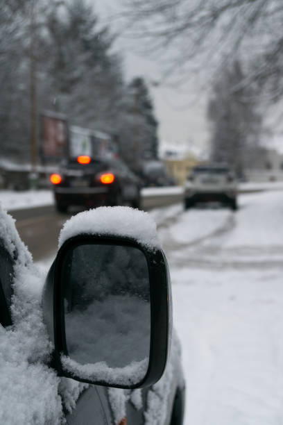 istock Rear car mirror with snow during winter. 908359450