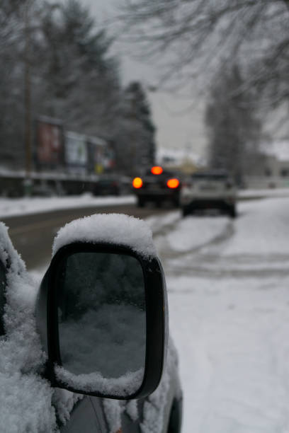 istock Rear car mirror with snow during winter. 908359466