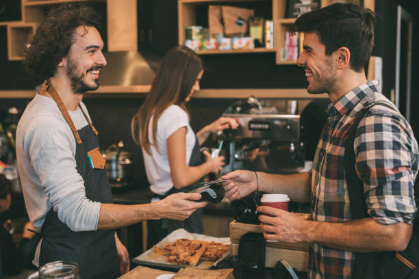 istock Customer paying with a credit card at a coffee shop 908362964
