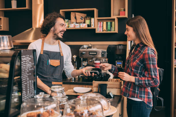 istock Customer paying with a credit card at a coffee shop 908362988