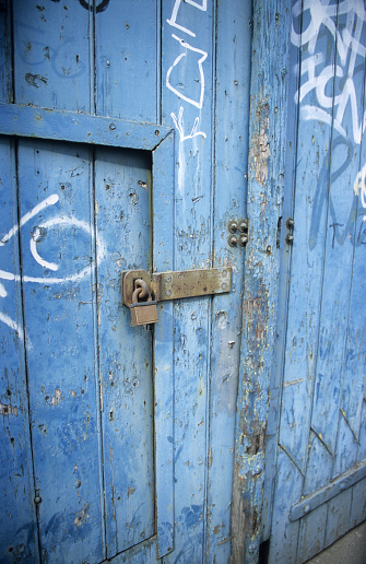 A lock on a blue warehouse door.