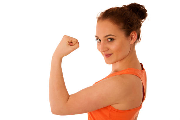 istock Woman showing her arm as a gesture for strrength 908367354