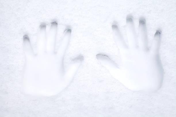 Imprint of a human palm on a frozen window glass inspires fear and horror. Close-up.