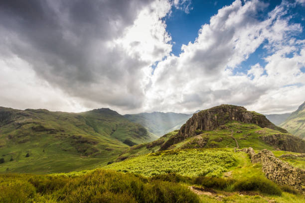 istock Beautiful mountain vista with sun beam shinning through the cloud 908370248