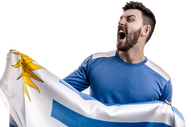 istock Uruguayan male athlete / fan celebrating on white background 908370816