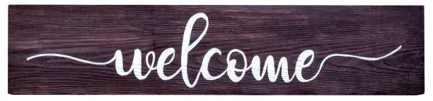 hand lettered script welcome sign painted on wood. Isolated with clipping path.