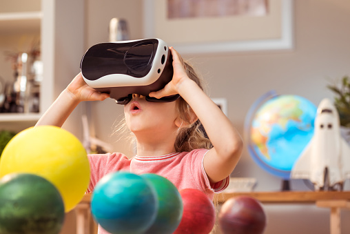 Little girl wearing virtual reality glasses