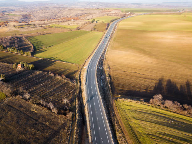 istock Aerial view of a road and colorful fields around 908385518