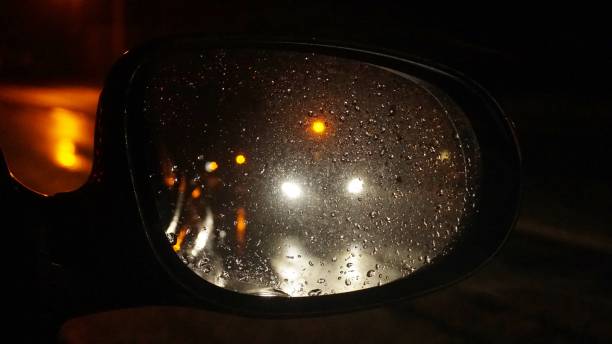 istock Reflection of Car Lights in Wing Mirror at Night 908389000