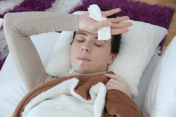 istock Young sick woman laying in bed 908391748