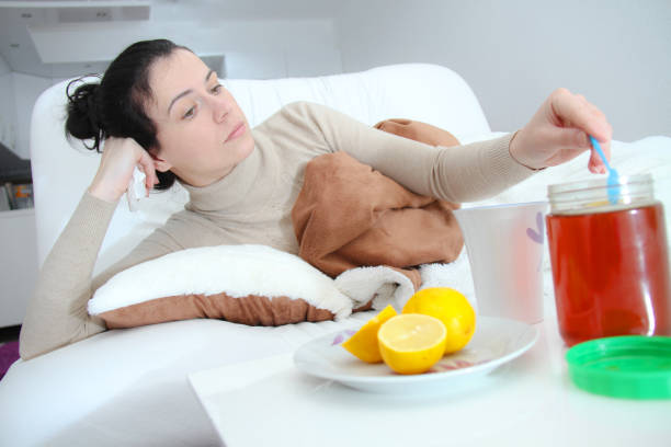 Young sick woman laying in bed Young sick woman laying in bedYoung sick woman laying in bed Drug Rehab vs Detox stock pictures, royalty-free photos & images