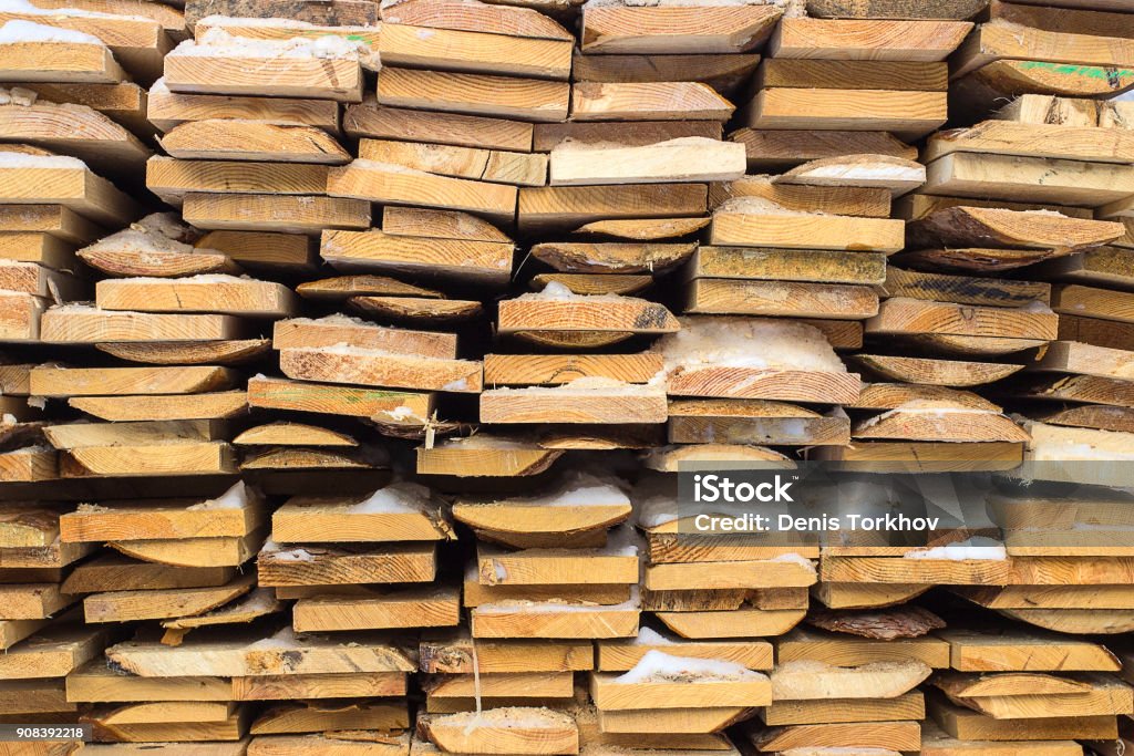 Wooden boards, lumber, industrial wood, timber. Building bar from a tree and an edging board in stacks. Brick Stock Photo