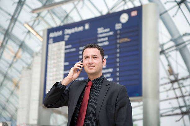 Businessman at airport, serious face stock photo