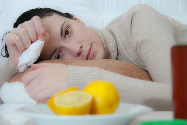 istock Young sick woman laying in bed 908395442