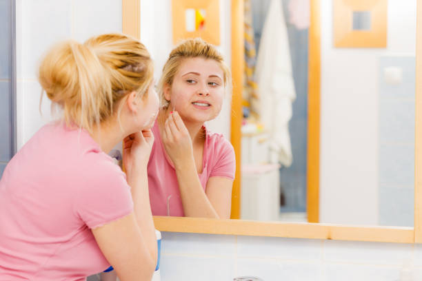 istock woman removing peel off mask from her face 908398650