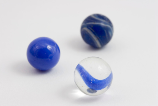 Three blue marbles with shallow depth of field.