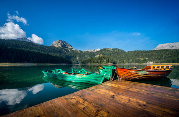 istock Boats on a mountain lake 908419274