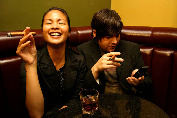 Prank Call A young couple in a bar arranging a prank call.  Shot at the Alberta Minilypse 2006. noah young stock pictures, royalty-free photos & images