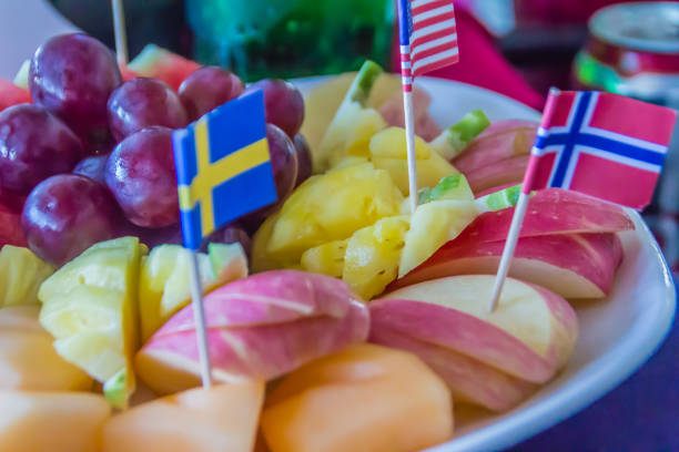 istock Fresh chopped and chunks fruits with flags on dish served in the restaurant. 908420692