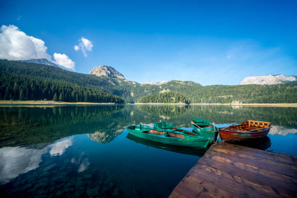 istock Boats on a mountain lake 908425752