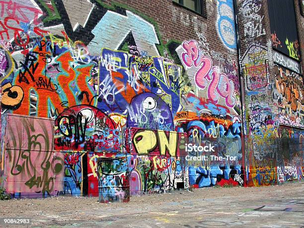 Graffiti Wall With Many Colored Murals Stock Photo - Download Image Now - Graffiti, Street, Wall - Building Feature
