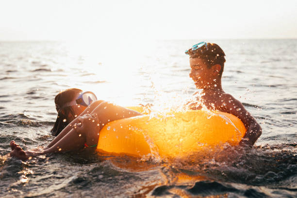 istock Friends having fun in sea 908430628