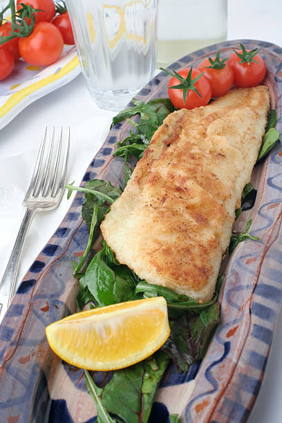 istock fish and salad on earthenware platters; water glass 90843086