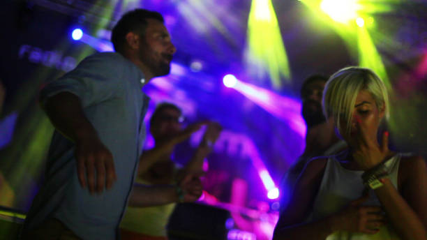 istock Four people dancing in front of stage 908436296
