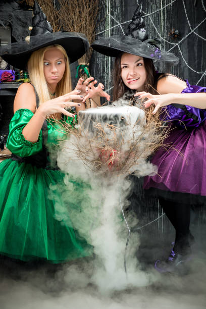 istock cheerful witches cook a potion for Halloween in the pot 908436414