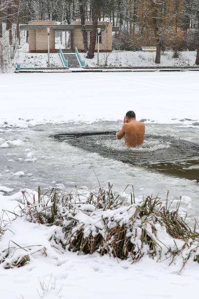 istock Bathing in the ice-hole in  Epiphany Day. 908443394