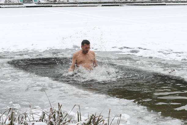 istock Bathing in the ice-hole in  Epiphany Day. 908443396