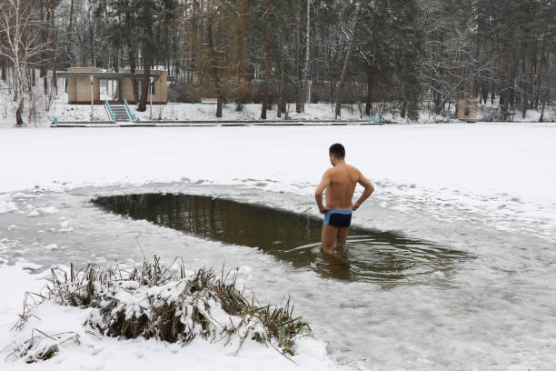 istock Bathing in the ice-hole in  Epiphany Day. 908443398