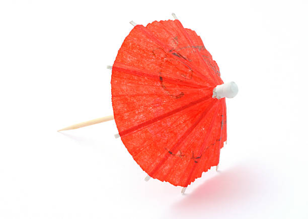 red asian cocktail umbrella on white  drink umbrella stock pictures, royalty-free photos & images