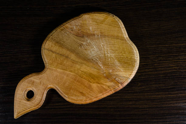 istock Cutting board on the dark wooden table. Top view 908449850