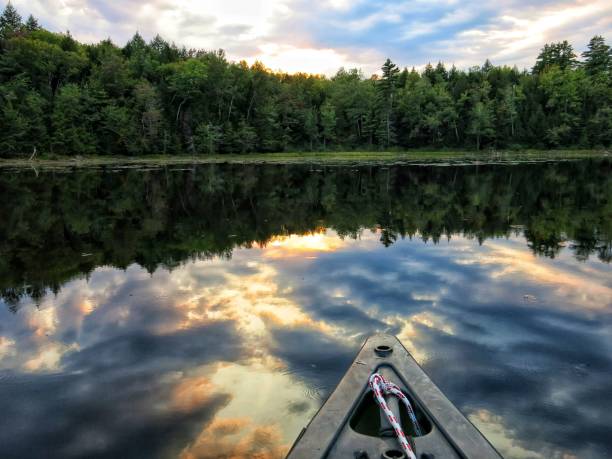 istock Canoe, Treelined Adirondack Crane Pond Sunset Reflection on Water. Lilypads 908450536