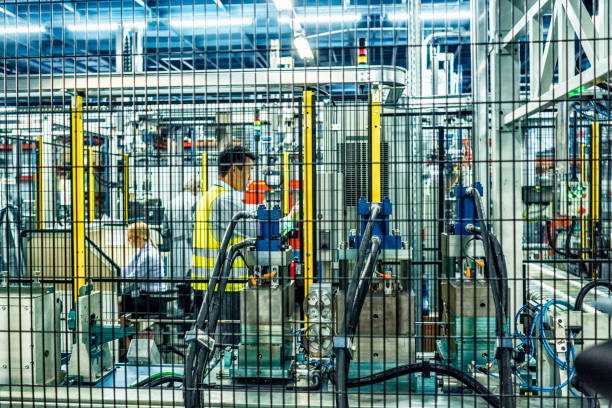 istock Two engineers behind machinery in a factory 908451008