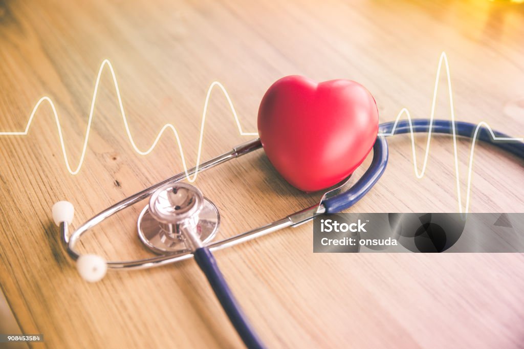 stethoscope and red heart with cardiogram red rubber heart and stethoscope with cardiogram on wood background, health concept Heart Shape Stock Photo