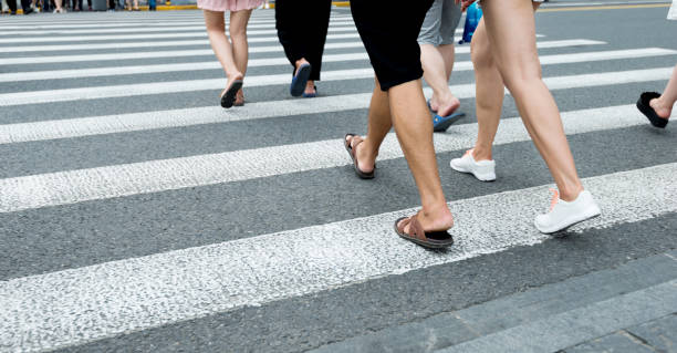 istock Group of people walking on crosswalk 908462572
