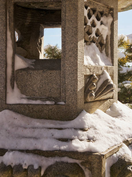 istock Detail of snow on stone lantern 908462724