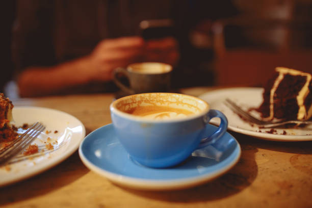 istock Coffee and cake on the table in a cafe in East London 908465012