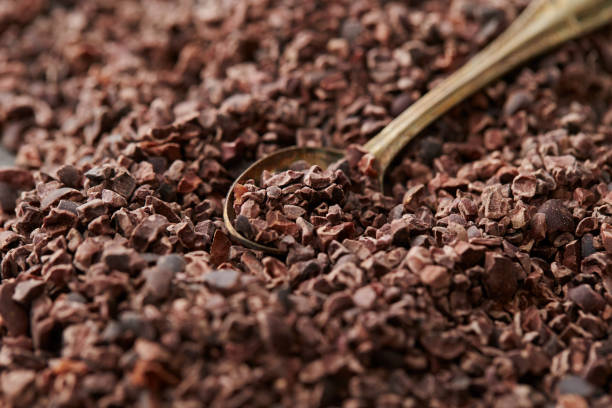 Cacao nibs Cacao nibs with spoon nib stock pictures, royalty-free photos & images