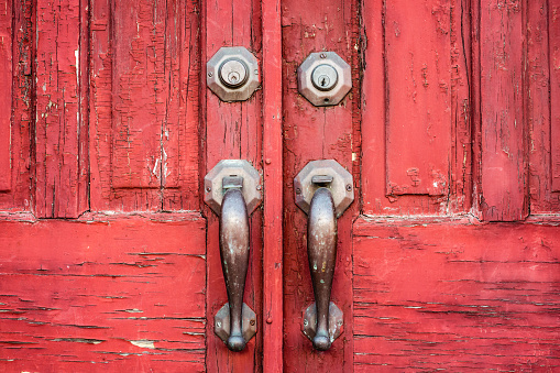 A detail of handles on an old double door