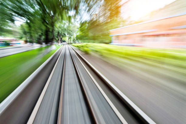 Blurred railway track and city street
