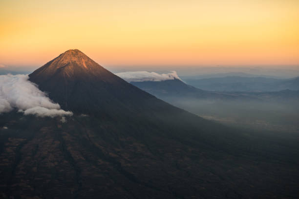 Agua volcano sunset Agua volcano outside Antigua, Guatemala taken at sunset from Acatenango volcano. agua volcano photos stock pictures, royalty-free photos & images