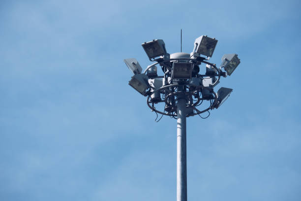 istock Lamp post electricity industry with blue sky. Spotlight tower. 908483898