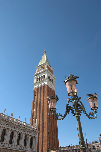 Traditional venetian lamppost and view of San Giorgio Maggiore island. San Giorgio Maggiore is one of the islands of Venice, lying east of the Giudecca and south of the main island group. Its Palladian church is an important landmark. It has been much painted, featuring for example in a series by Monet.
